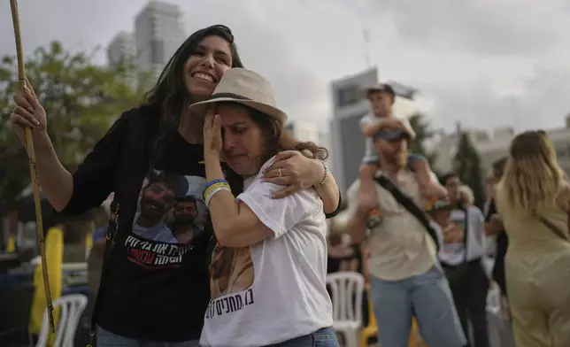 People watch a live broadcast of Israeli-American soldier Edan Alexander as he is released from Hamas captivity in Gaza, at a plaza known as the hostages square in Tel Aviv, Monday, May 12, 2025. Alexander was abducted during the Hamas-led attack on his base on October 7, 2023. (AP Photo/Oded Balilty)