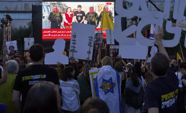 People watch a live broadcast of Israeli-American soldier Edan Alexander as he is released from Hamas captivity in Gaza, at a plaza known as the hostages square in Tel Aviv, Monday, May 12, 2025. Alexander was abducted during the Hamas-led attack on his base on October 7, 2023. (AP Photo/Oded Balilty)