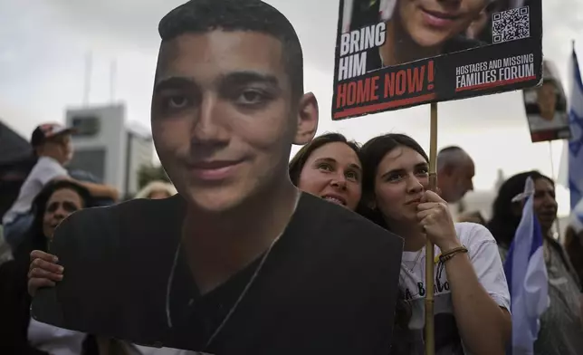 People watch a live broadcast of Israeli-American soldier Edan Alexander as he is released from Hamas captivity in Gaza, at a plaza known as the hostages square in Tel Aviv, Monday, May 12, 2025. Alexander was abducted during the Hamas-led attack on his base on October 7, 2023. (AP Photo/Oded Balilty)