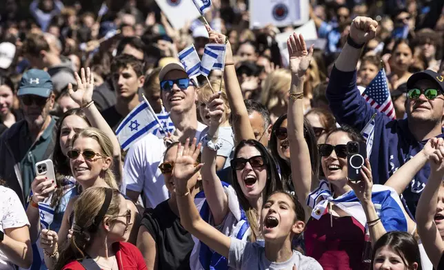 People gathered in Huyler Park celebrate the release of American hostage Edan Alexander from Hamas on Monday, May 12, 2025, in Tenafly, N.J. (AP Photo/Stefan Jeremiah)