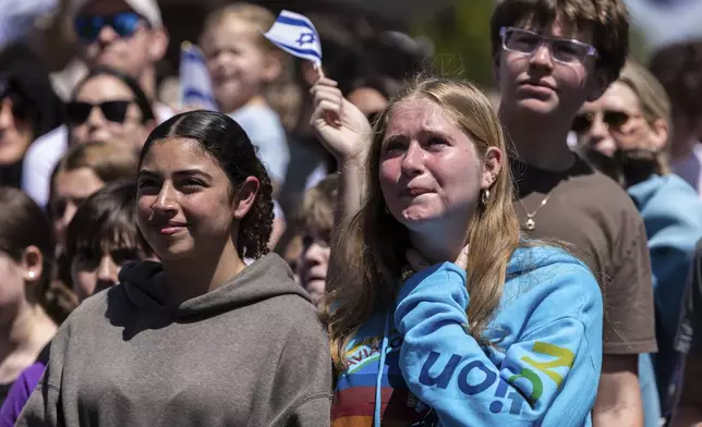 A person in Huyler Park weeps as they celebrate the release of American hostage Edan Alexander from Hamas on Monday, May 12, 2025, in Tenafly, N.J. (AP Photo/Stefan Jeremiah)