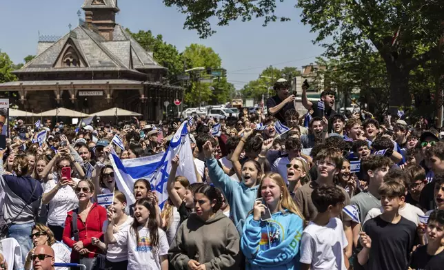 People gathered in Huyler Park celebrate the release of American hostage Edan Alexander from Hamas on Monday, May 12, 2025, in Tenafly, N.J. (AP Photo/Stefan Jeremiah)