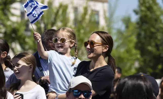 People gathered in Huyler Park celebrate the release of American hostage Edan Alexander from Hamas on Monday, May 12, 2025, in Tenafly, N.J. (AP Photo/Stefan Jeremiah)