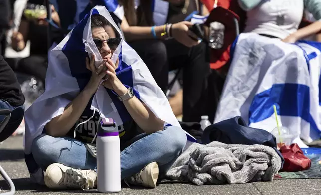 Residents and friends gather in Huyler Park ahead of the release of American hostage Edan Alexander from Hamas on Monday, May 12, 2025, in Tenafly, N.J. (AP Photo/Stefan Jeremiah)