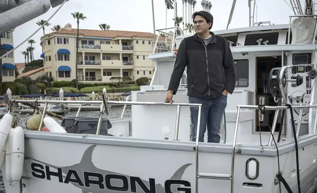 Blake Hermann, a fourth-generation commercial fisherman, poses for a portrait aboard his boat in Oxnard, Calif., Thursday, May 1, 2025. (AP Photo/Annika Hammerschlag)