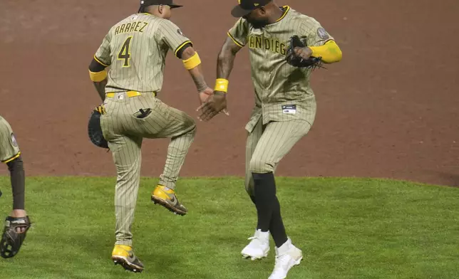 San Diego Padres' Luis Arraez (4) celebrates with Jason Heyward, right, after the final out of a baseball game against the Pittsburgh Pirates in Pittsburgh, Friday, May 2, 2025. (AP Photo/Gene J. Puskar)