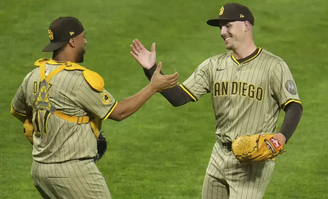 San Diego Padres pitcher Ryan Bergert, right, and catcher Elias Díaz, left, celebrate after the final out of a baseball game against the Pittsburgh Pirates in Pittsburgh, Friday, May 2, 2025. (AP Photo/Gene J. Puskar)