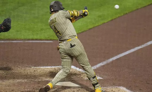 San Diego Padres' Luis Arraez drives in a run with a single off Pittsburgh Pirates pitcher Caleb Ferguson during the eighth inning of a baseball game in Pittsburgh, Friday, May 2, 2025. (AP Photo/Gene J. Puskar)