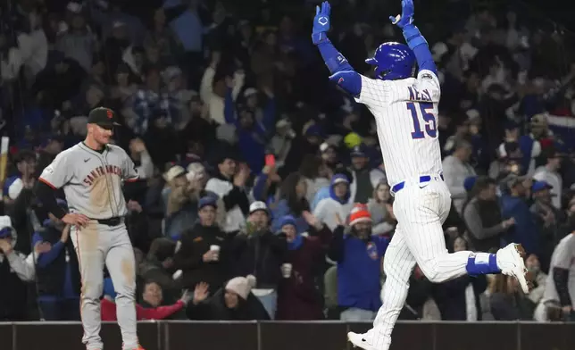 Chicago Cubs' Carson Kelly, right, celebrates as he rounds the bases after hitting a solo home run as San Francisco Giants third baseman Matt Chapman, left, reacts during the sixth inning of a baseball game in Chicago, Monday, May 5, 2025. (AP Photo/Nam Y. Huh)