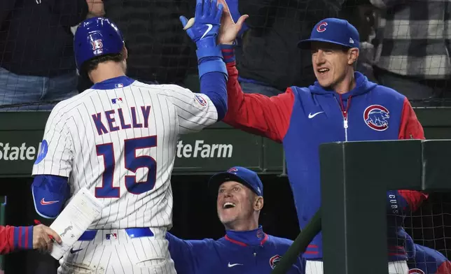 Chicago Cubs' Carson Kelly, left, celebrates with manager Craig Counsell, right, after hitting a solo home run during the sixth inning of a baseball game against the San Francisco Giants in Chicago, Monday, May 5, 2025. (AP Photo/Nam Y. Huh)