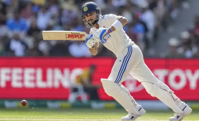 FILE - India's Virat Kohli watches the ball after playing a shot during play on the second day of the fourth cricket test between Australia and India at the Melbourne Cricket Ground, Melbourne, Australia, on Dec. 27, 2024. (AP Photo/Asanka Brendon Ratnayake, File)