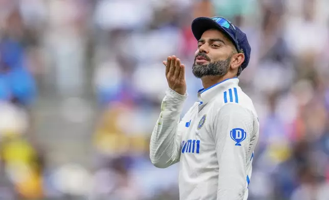 FILE - India's Virat Kohli gestures to a member of a crowd during play on the first day of the fourth cricket test between Australia and India at the Melbourne Cricket Ground, Melbourne, Australia, on Dec. 26, 2024. (AP Photo/Asanka Brendon Ratnayake, File)
