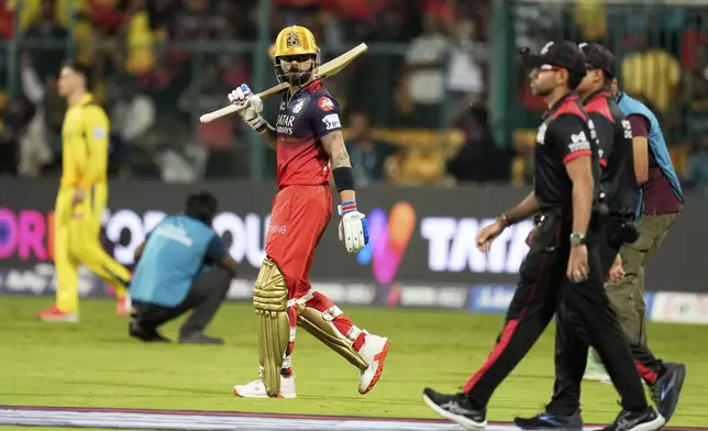 Royal Challengers Bengaluru's Virat Kohli, center, enters the field for the Indian Premier League cricket match between Chennai Super Kings and Royal Challengers Bengaluru at Chinnaswamy Stadium in Bengaluru, India, Saturday, May 3, 2025. (AP Photo/Aijaz Rahi)