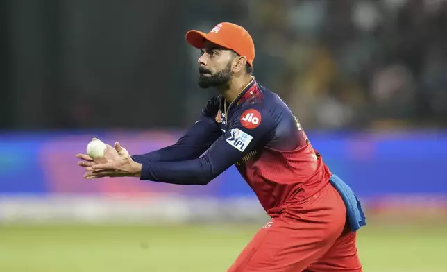 Royal Challengers Bengaluru's Virat Kohli catches the ball before passing it on to the bowler during the Indian Premier League cricket match between Royal Challengers Bengaluru and Chennai Super Kings at Chinnaswamy Stadium in Bengaluru, India, Saturday, May 3, 2025. (AP Photo/Aijaz Rahi)