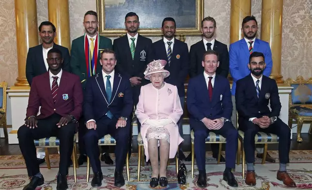 FILE - Britain's Queen Elizabeth II joins the captains of the teams taking part in the ICC Cricket World Cup for a photograph in the 1844 Room at Buckingham Palace, before a Royal Garden Party in London, on May 29, 2019. Back row from left, Pakistan's Sarfaraz Ahmed, South Africa's Francois du Plessis, Bangladesh's Masrafe Bin Mortaza, Sri Lanka's Dimuth Karunaratne, New Zealand's Kane Williamson and Afghanistan's Gulbadin Naib. Front row from left, West Indies' Jason Holder, Australia's Aaron Finch, England's Eoin Morgan and India's Virat Kohli. (Yui Mok/Pool photo via AP, File)