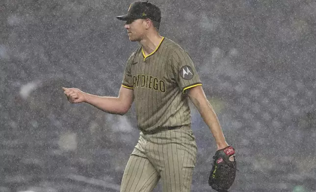 San Diego Padres pitcher Nick Pivetta stands in the rain during the fourth inning of a baseball game against the New York Yankees, Monday, May 5, 2025, in New York. (AP Photo/Pamela Smith)