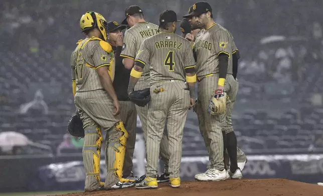 San Diego Padres players talk on the pitcher's mound during the fifth inning of a baseball game against the New York Yankees, Monday, May 5, 2025, in New York. (AP Photo/Pamela Smith)