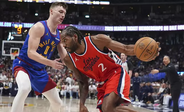 Los Angeles Clippers forward Kawhi Leonard, right, drives to the basket as Denver Nuggets guard Christian Braun, left, defends in the second half of Game 7 of an NBA basketball first-round playoff series Saturday, May 3, 2025, in Denver. (AP Photo/David Zalubowski)