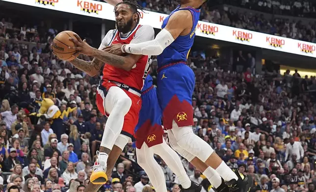 Los Angeles Clippers forward Derrick Jones Jr., left, drives to the basket as Denver Nuggets guards Christian Braun, back left, and Russell Westbrook, right, defend in the second half of Game 7 of an NBA basketball first-round playoff series Saturday, May 3, 2025, in Denver. (AP Photo/David Zalubowski)