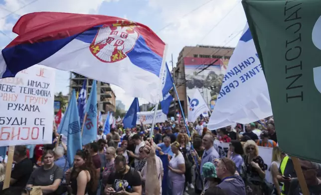 University students and people protest in front of the government building, six months after the deadly train station tragedy that sparked mass demonstrations against corruption, in Belgrade, Serbia, Thursday, May 1, 2025. (AP Photo/Darko Vojinovic)