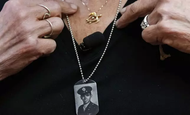 Diane Christie wears a necklace with a photograph of her uncle, World War II U.S. Army Air Forces 2nd Lt. Thomas Kelly, inside Santos Robinson Mortuary, Friday, May 23, 2025, in San Leandro, Calif. whose remains had been missing since being killed when the World War II bomber nicknamed Heaven Can Wait was hit by anti-aircraft fire and crashed into the water off the coast of New Guinea on March 11, 1944. (AP Photo/Godofredo A. Vásquez)