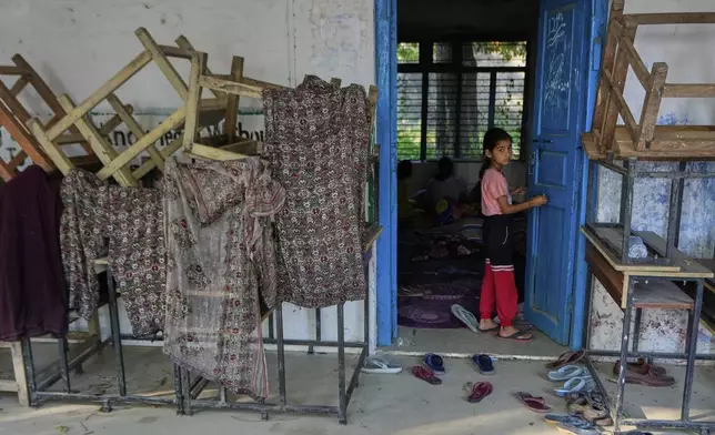 A girl evacuated from her village along the India Pakistan border takes refuge in a makeshift center in a school at RS Pura, along the International Border, India, Monday, May 12, 2025. (AP Photo/Channi Anand)
