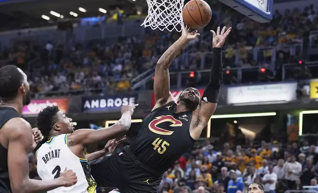 Cleveland Cavaliers guard Donovan Mitchell (45) shoots against Indiana Pacers center Thomas Bryant (3) in the first half of Game 4 in the Eastern Conference semifinals of the NBA basketball playoffs in Indianapolis, Sunday, May 11, 2025. (AP Photo/Michael Conroy)