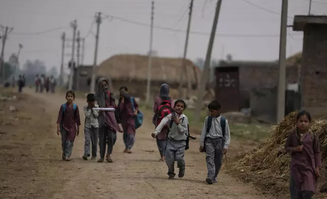 Indian students walk home after attending school near international border India Pakistan at Jora farm village, in Ranbir Singh Pura about 35 kilometers (22 miles) from Jammu, India, Tuesday, May 6, 2025. (AP Photo/Channi Anand)