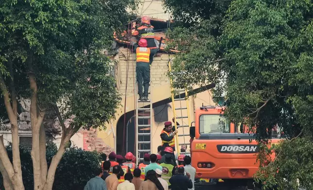 Rescue workers recover a body from a damaged building at the site of a suspected Indian missile attack, in Muridke, a town in Pakistan's Punjab province, Wednesday, May 7, 2025. (AP Photo/K.M. Chaudary)