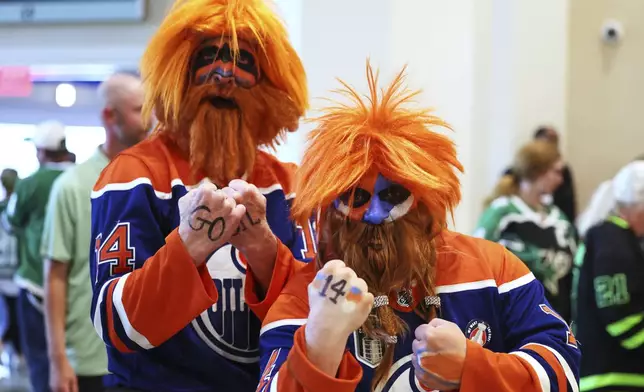 Greg Debogorski, left, and Stu Impett pose for a photo before Game 5 of the Western Conference finals in the NHL hockey Stanley Cup playoffs Thursday, May 29, 2025, in Dallas. (AP Photo/Gareth Patterson)