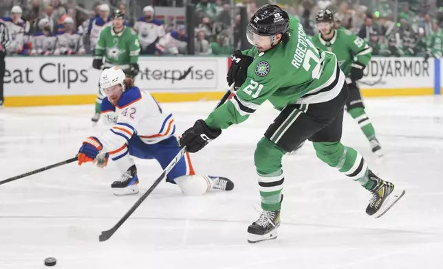 Dallas Stars left wing Jason Robertson (21) scores against the Edmonton Oilers during the third period of Game 5 of the Western Conference finals in the NHL hockey Stanley Cup playoffs, Thursday, May 29, 2025, in Dallas. (AP Photo/Julio Cortez)