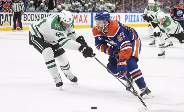 Dallas Stars' Cody Ceci defends against Edmonton Oilers' Connor McDavid (97) during the second period of Game 3 of the NHL hockey Stanley Cup Western Conference finals in Edmonton, Alberta, Sunday, May 25, 2025. (Jason Franson/The Canadian Press via AP)