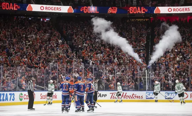 Edmonton Oilers players celebrate a goal against the Dallas Stars during the third period in Game 4 of the Western Conference finals in the NHL hockey Stanley Cup playoffs in Edmonton, Alberta, Tuesday, May 27, 2025. (Jason Franson/The Canadian Press via AP)