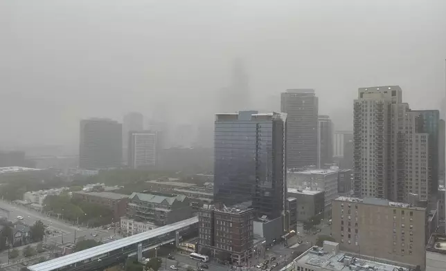 A dust storm that originated in central Illinois moves through downtown Chicago on the evening of Friday, May 16, 2025. (AP Photo/Kathleen Foody)