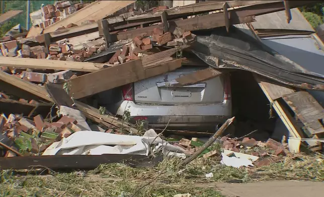 Debris covers the ground and a vehicle after a severe storm passed the area on Saturday, May 17, 2025 in St. Louis, Mo. ( KMOV via AP)