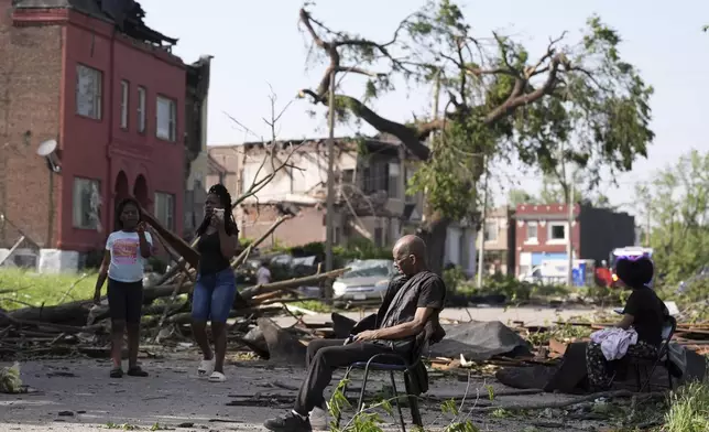 A man sits in a chair after a severe storm moved through St. Louis, Missouri, Friday, May 16, 2025. (AP Photo/Jeff Roberson)