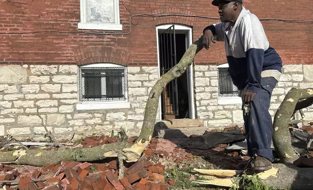Greg Simmons, 55, a St. Louis resident, surveyed damage after a storm ripped the roof off of his home on Friday, May 16, 2025. (AP Photo/Michael Phillis)