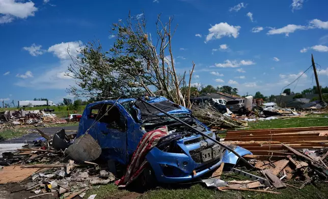 A vehicle is covered in debris after a severe storm passed the area on Saturday, May 17, 2025,in London, Ky. (AP Photo/Carolyn Kaster)