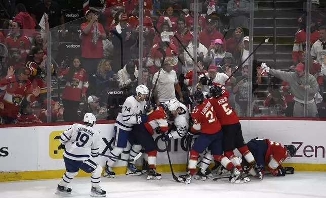 Florida Panthers players clash with Toronto Maple Leafs players after Game 4 of a second-round NHL hockey playoff series, Sunday, May 11, 2025, in Sunrise, Fla. (AP Photo/Michael Laughlin)