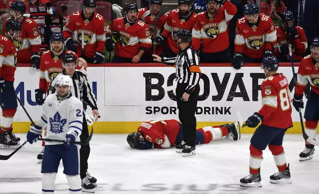 Florida Panthers center Evan Rodrigues (17) lies on the ice during the third period of Game 4 of a second-round NHL hockey playoff series against the Toronto Maple Leafs, Sunday, May 11, 2025, in Sunrise, Fla. (AP Photo/Michael Laughlin)