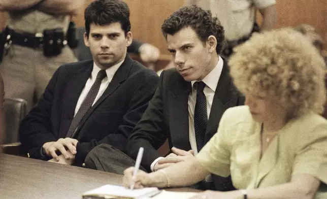 FILE - Lyle, left, and Erik Galen Menendez sit in Beverly Hills, Calif., courtroom, May 14, 1990 as a judge postponed their preliminary hearing on charges of murdering their parents last August. (AP Photo/Kevork Djansezian, File)