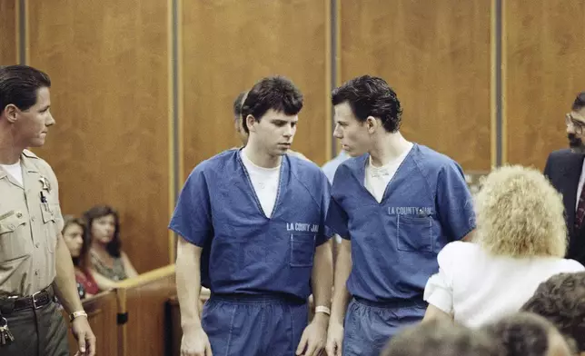 FILE - Lyle, left, and Erik Menendez leave a courtroom in Santa Monica, Calif., Aug. 6, 1990, after a judge ruled that conversations between the brothers and their psychologist after their parents were slain were not privileged and could be used as evidence. (AP Photo/Nick Ut, File)
