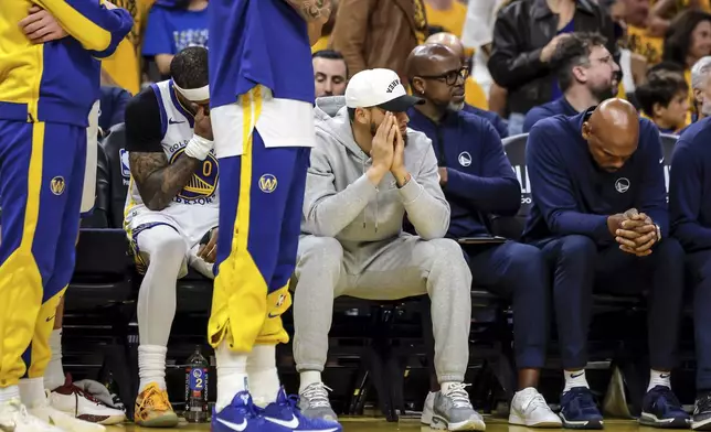 Golden State Warriors' Stephen Curry (30) and other players watch from the bench during Game 3 of an NBA basketball second-round playoff series against the Minnesota Timberwolves in San Francisco, Saturday, May 10, 2025. (Carlos Avila Gonzalez/San Francisco Chronicle via AP)
