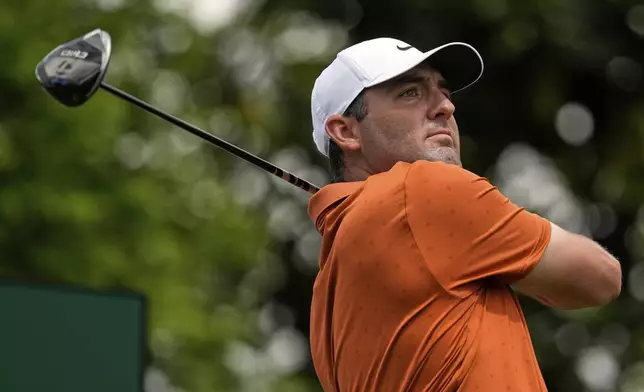 Scottie Scheffler watches his tee shot on the 14th hole during a practice round for the PGA Championship golf tournament at the Quail Hollow Club, Wednesday, May 14, 2025, in Charlotte, N.C. (AP Photo/George Walker IV)