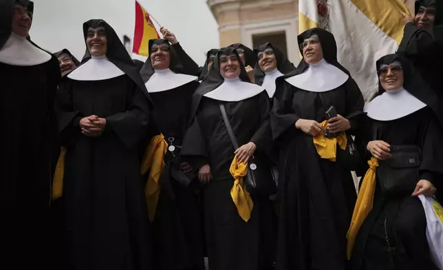 Spanish nuns gather near the Vatican, in Rome, on Wednesday, May 7, 2025, on the day cardinals sequester themselves at the Vatican for the start of a conclave to elect the 267th Roman pontiff, a successor to Pope Francis. (AP Photo/Francisco Seco)