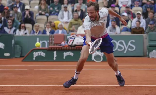 Russia's Daniil Medvedev returns the ball to Britain's Cameron Norrie during their first round match of the French Tennis Open, at the Roland-Garros stadium, in Paris, Tuesday, May 27, 2025. (AP Photo/Thibault Camus)
