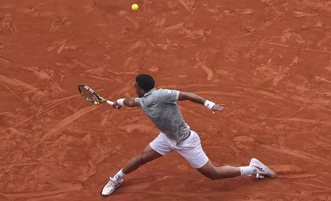 France's Arthur Fils returns the ball to Chile's Nicolas Jarry during their first round match of the French Tennis Open, at the Roland-Garros stadium, in Paris, Monday, May 26, 2025. (AP Photo/Lindsey Wasson)