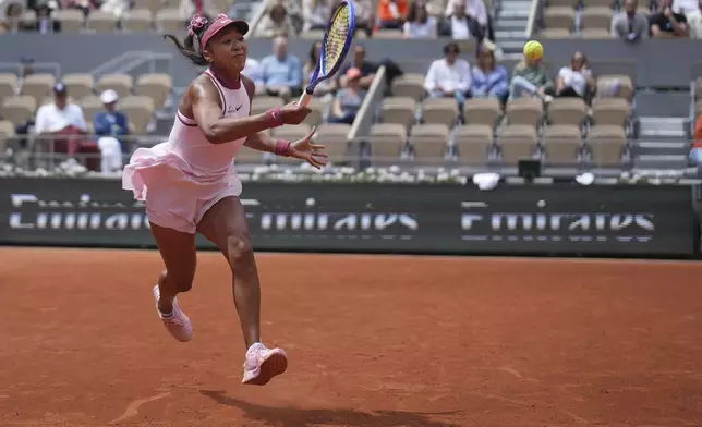 Japan's Naomi Osaka returns the ball to Spain's Paula Badosa during their first round match of the French Tennis Open, at the Roland-Garros stadium, in Paris, Monday, May 26, 2025. (AP Photo/Christophe Ena)