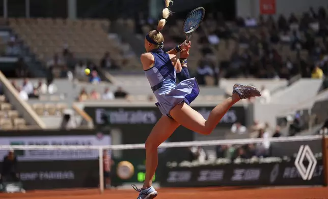 Slovakia's Rebecca Sramkova returns the ball to Poland's Iga Swiatek during their first round match of the French Tennis Open, at the Roland-Garros stadium, in Paris, Monday, May 26, 2025. (AP Photo/Lindsey Wasson)