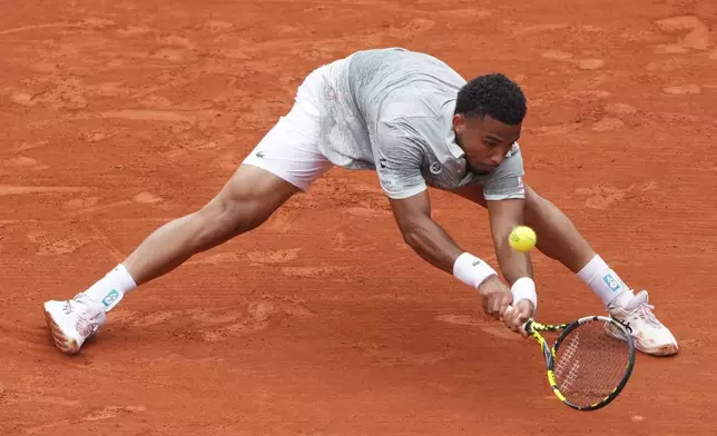 France's Arthur Fils reaches for the ball as he plays Chile's Nicolas Jarry during their first round match of the French Tennis Open, at the Roland-Garros stadium, in Paris, Monday, May 26, 2025. (AP Photo/Lindsey Wasson)
